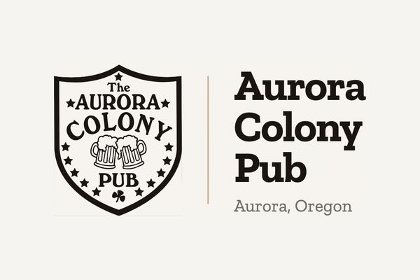 The Aurora Colony Pub shield logo, with two beer mugs, beside the pub name and "Aurora, Oregon".
